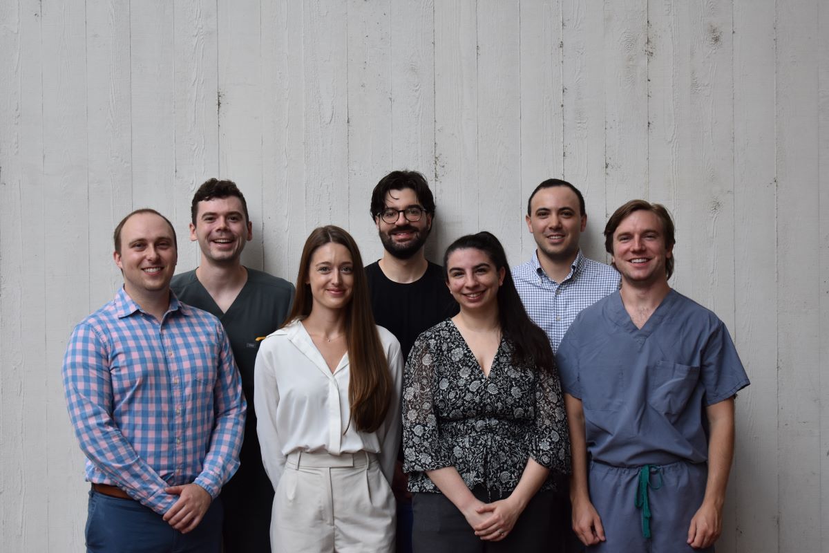 seven radiology residents smiling and standing side by side