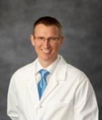 White coat portrait of Dr Christopher Bailey