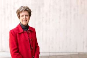 Portrait of Dr Ann Fulcher in red coat