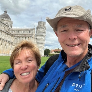 woman and man standing in front of the leaning tower of Pisa in Italy