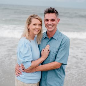 Kelley Whitmer on right with wife standing on a beach