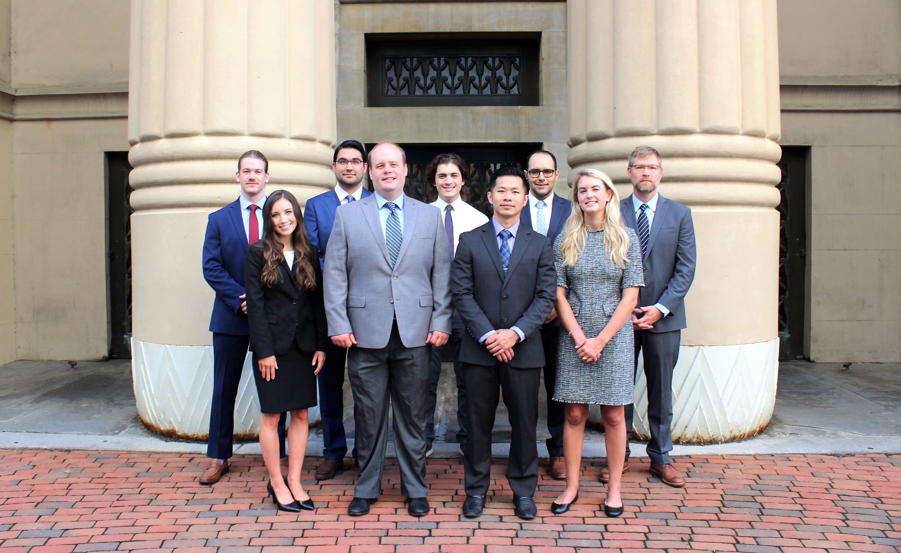 Group of nine radiology residents in the class of 2021 outside the V C U Egyptian building