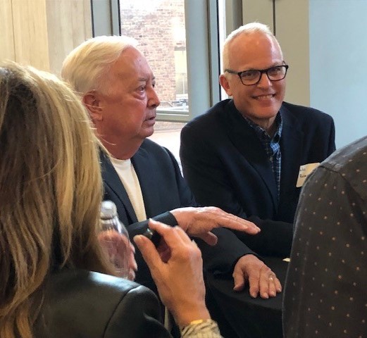 Two male doctors talking sitting at a table