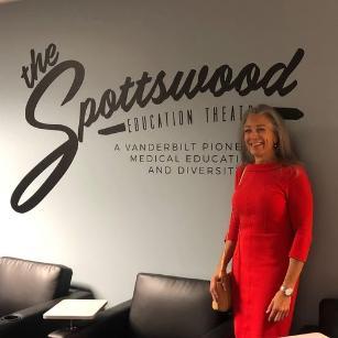 Stephanie Spottswood standing next to her name on the wall of a new radiology education theater at Vanderbilt